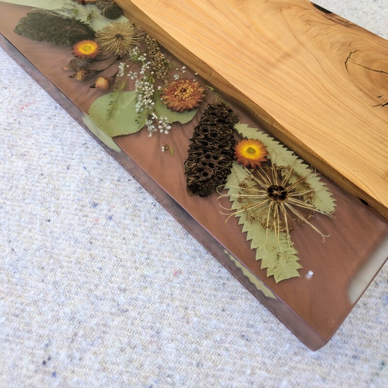 This charcuterie board will be great On mums’ special day, go beyond the ordinary and gift your mum something extraordinary with this handcrafted Flora, timber and resin grazing board that embodies love, artistry, and the timeless beauty of Australia. Let every meal shared on this board be a celebration of the bond you share, the memories you create, and the love that binds you together.