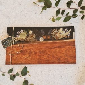 Serve charcuterie with this stunning Australian inspired charcuterie board made from timber, resin and Australian native flora.
