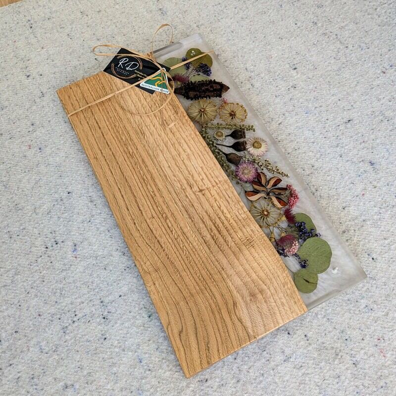 Celebrate any special occasion with this exquisite keepsake Australian Flora timber cheese board – a luxurious gift for that special day! Crafted with native Australian flora designs, it exudes elegance and charm. Perfect for pampering moments, its not just a cheese board but a beautiful addition to home décor. This thoughtful gift will surely to make anyone feel cherished and loved. Make someone's day extra special with this unique and stylish cheese board – a perfect blend of functionality and beauty!