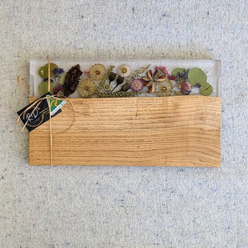Celebrate any special occasion with this exquisite keepsake Australian Flora timber cheese board – a luxurious gift for that special day! Crafted with native Australian flora designs, it exudes elegance and charm. Perfect for pampering moments, its not just a cheese board but a beautiful addition to home décor. This thoughtful gift will surely to make anyone feel cherished and loved. Make someone's day extra special with this unique and stylish cheese board – a perfect blend of functionality and beauty!