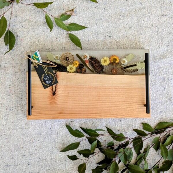 Each board is a one-of-a-kind masterpiece, meticulously handcrafted to showcase the rich textures of timber and the vibrant hues of resin intertwined with native Australian botanicals.