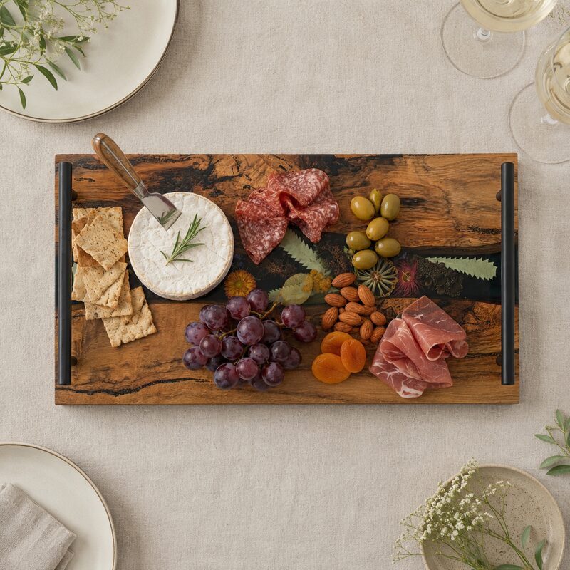 Australian wildflower charcuterie board naturally styled with cheese, crackers, cured meats, grapes, olives and nuts.