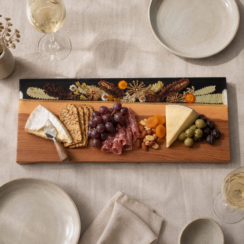 Large Australian botanical serving board styled with cheese, crackers, cured meat, grapes, olives, nuts and dried fruit.