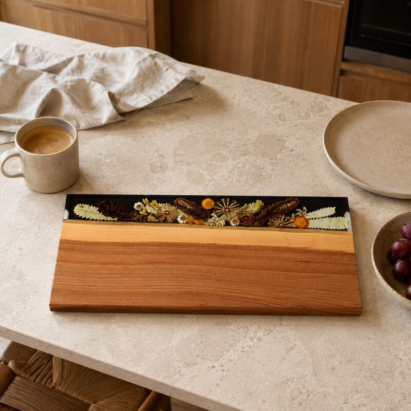Large two-tone timber and botanical resin serving board displayed flat in a contemporary Australian kitchen.