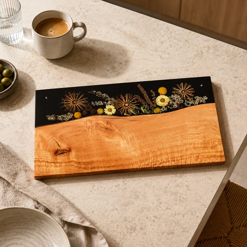 Handmade Australian timber and botanical resin serving platter displayed flat in a warm contemporary kitchen.