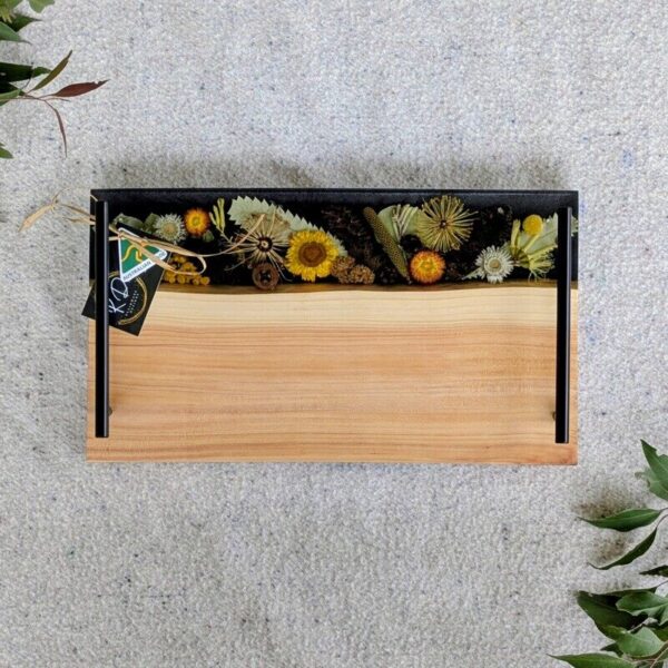 Celebrate Australia with our handcrafted serving platter. Made from locally sourced timber, resin, and dried Australian flora, it serves as a functional cheese board and a showcase of Australia’s beauty. Perfect for gifting, each board blends native timber with translucent resin and preserved flora, capturing the essence of our landscapes. Presented in elegant packaging, it’s a thoughtful gift ready for worldwide shipping.