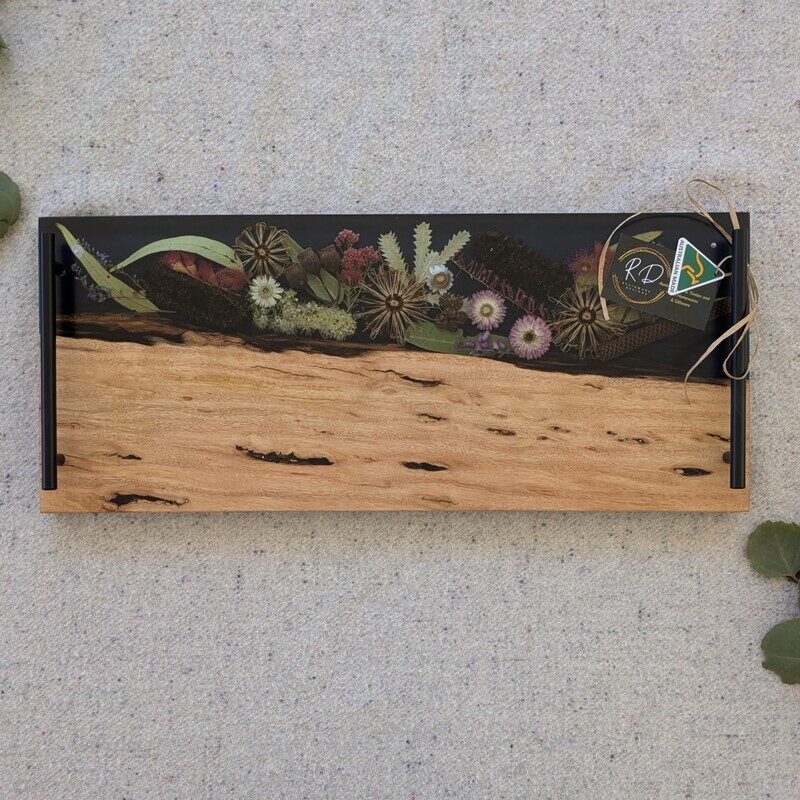 Discover the beauty of Australia’s landscapes in a functional piece of art with our unique cheese board. Made from locally sourced timber, resin, and dried Australian flora, each board is a testament to artisanal craftsmanship and the natural splendor of our continent. Designed to elevate your home decor, our cheese boards are not just serving essentials but exquisite pieces that showcase Australia’s stunning flora. Each board features carefully arranged dried native flora encased in translucent resin, creating a mesmerizing display of colors and textures. Whether displayed on your kitchen counter or used to serve guests, it becomes a focal point that sparks conversation and admiration.