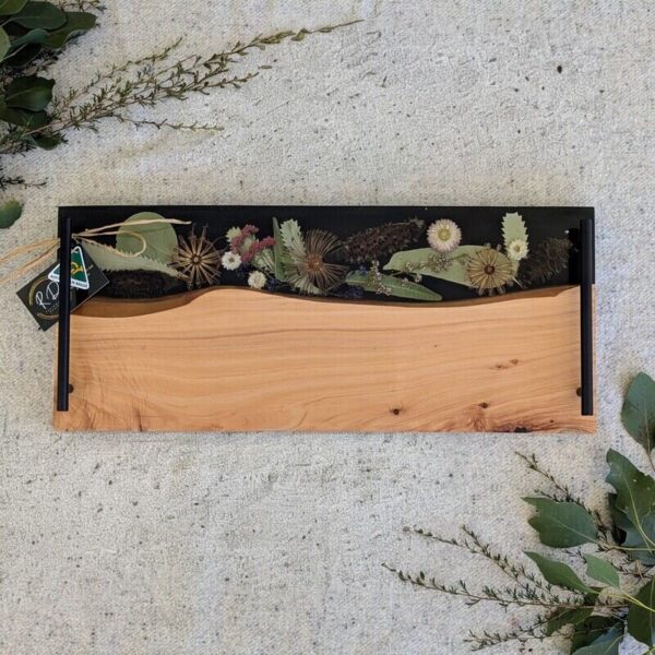 Designed to elevate your home decor, our cheese boards are not just serving essentials but exquisite pieces that showcase Australia’s stunning flora. Each board features carefully arranged dried native flora encased in translucent resin, creating a mesmerizing display of colors and textures. Whether displayed on your kitchen counter or used to serve guests, it becomes a focal point that sparks conversation and admiration.