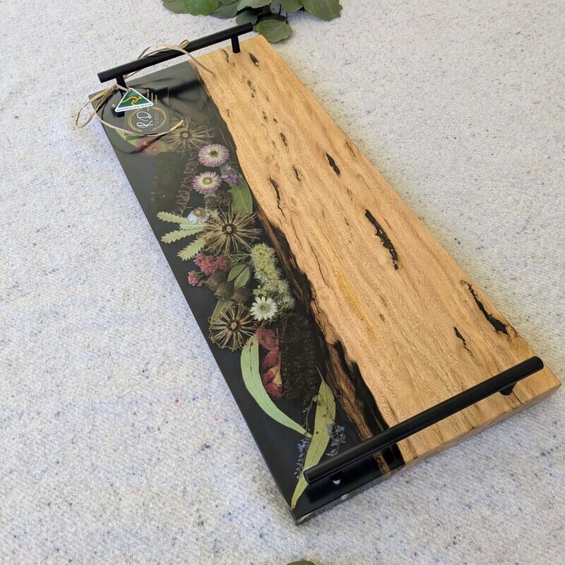 Discover the beauty of Australia’s landscapes in a functional piece of art with our unique cheese board. Made from locally sourced timber, resin, and dried Australian flora, each board is a testament to artisanal craftsmanship and the natural splendor of our continent. Designed to elevate your home decor, our cheese boards are not just serving essentials but exquisite pieces that showcase Australia’s stunning flora. Each board features carefully arranged dried native flora encased in translucent resin, creating a mesmerizing display of colors and textures. Whether displayed on your kitchen counter or used to serve guests, it becomes a focal point that sparks conversation and admiration.