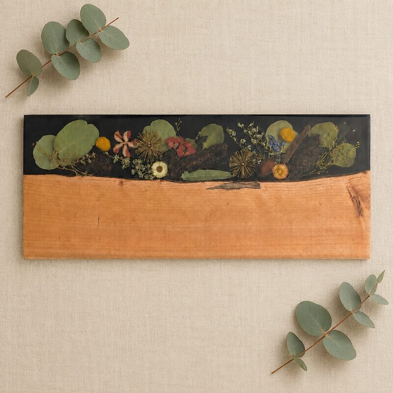 Large Australian timber and dark botanical resin serving board with preserved native flowers.