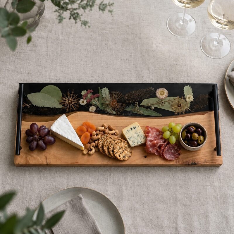 Styled grazing board Large timber and botanical resin serving board styled with cheese, crackers, cured meats, grapes, olives, nuts and dried fruit.