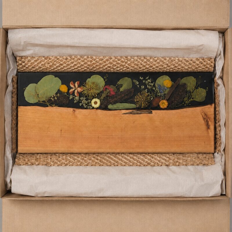 Australian timber and native botanical resin serving board presented in a natural kraft gift box.