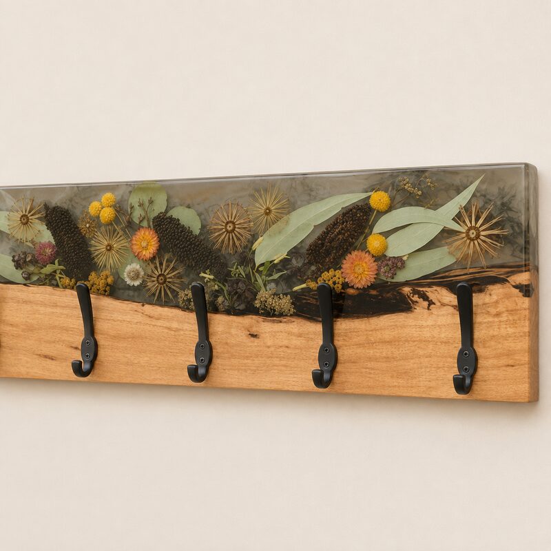 Close-up of preserved Australian botanicals, smoky resin and natural timber craftsmanship on a handmade coat rack.