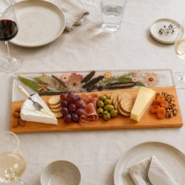 Large Australian botanical serving board naturally styled with cheese, crackers, cured meat, grapes, olives and nuts.